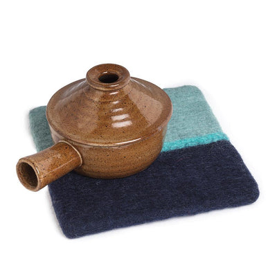 This 100% sheep wool square trivet is the perfect accessory for placing down hot pots, pans and dishes on kitchen counters and on your dinner table. The trivet is fair trade certified and actually handmade in Nepal by female artisans.